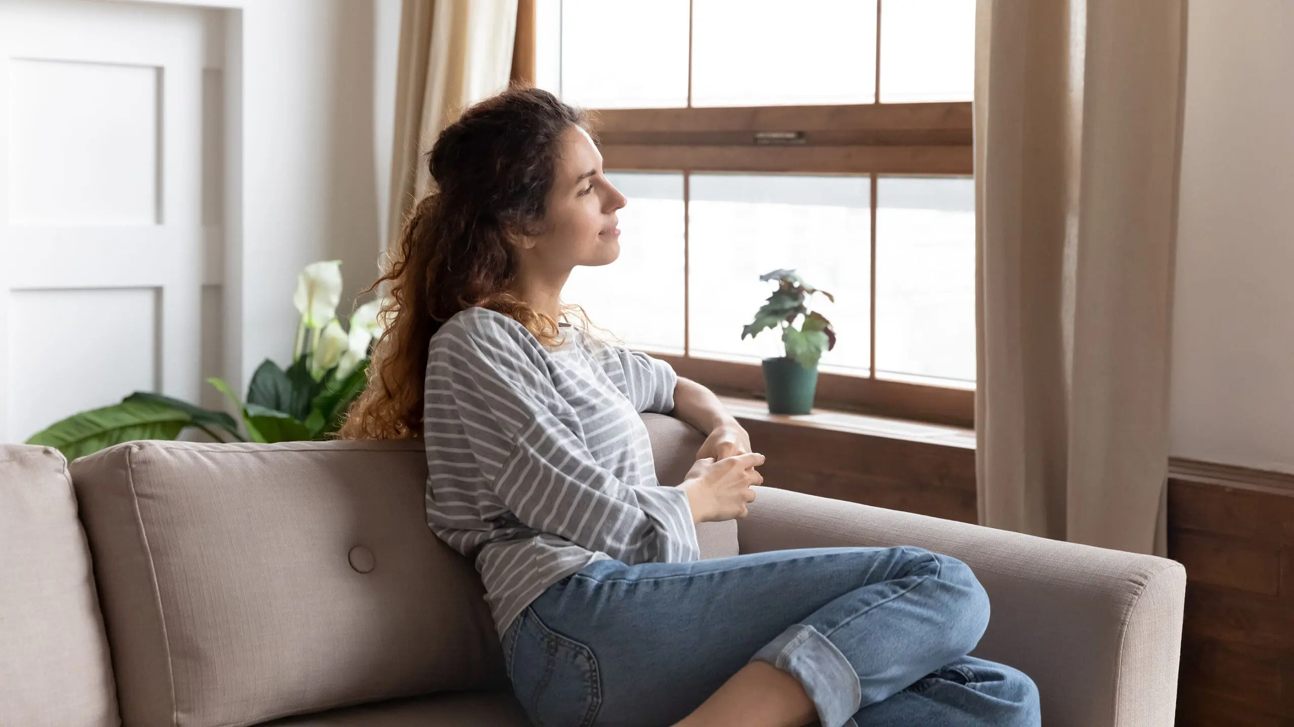 A woman wondering "How Much Does the Abortion Pill Cost Without Insurance?"