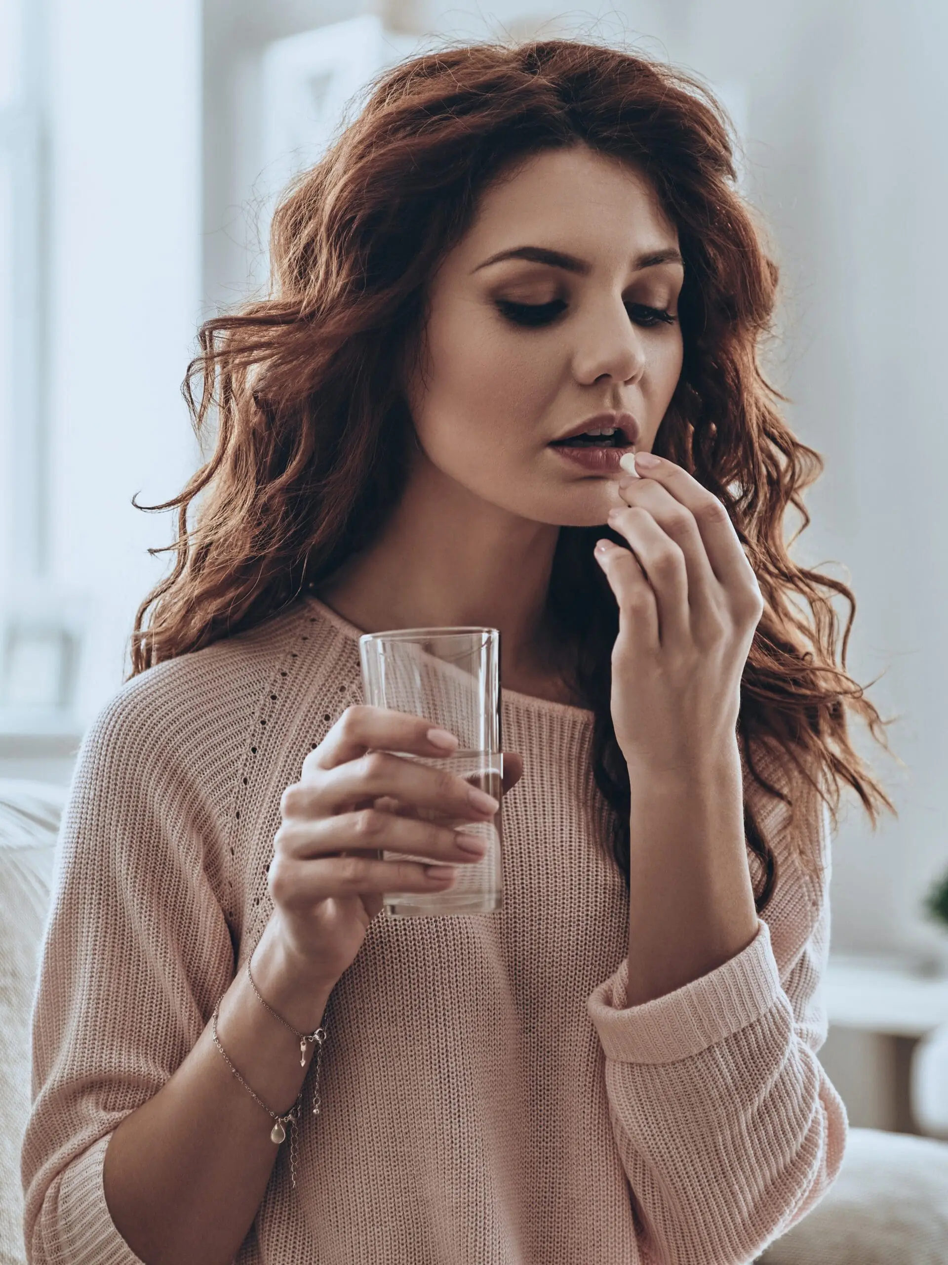 A woman wondering "How Does the Abortion Pill Work?"