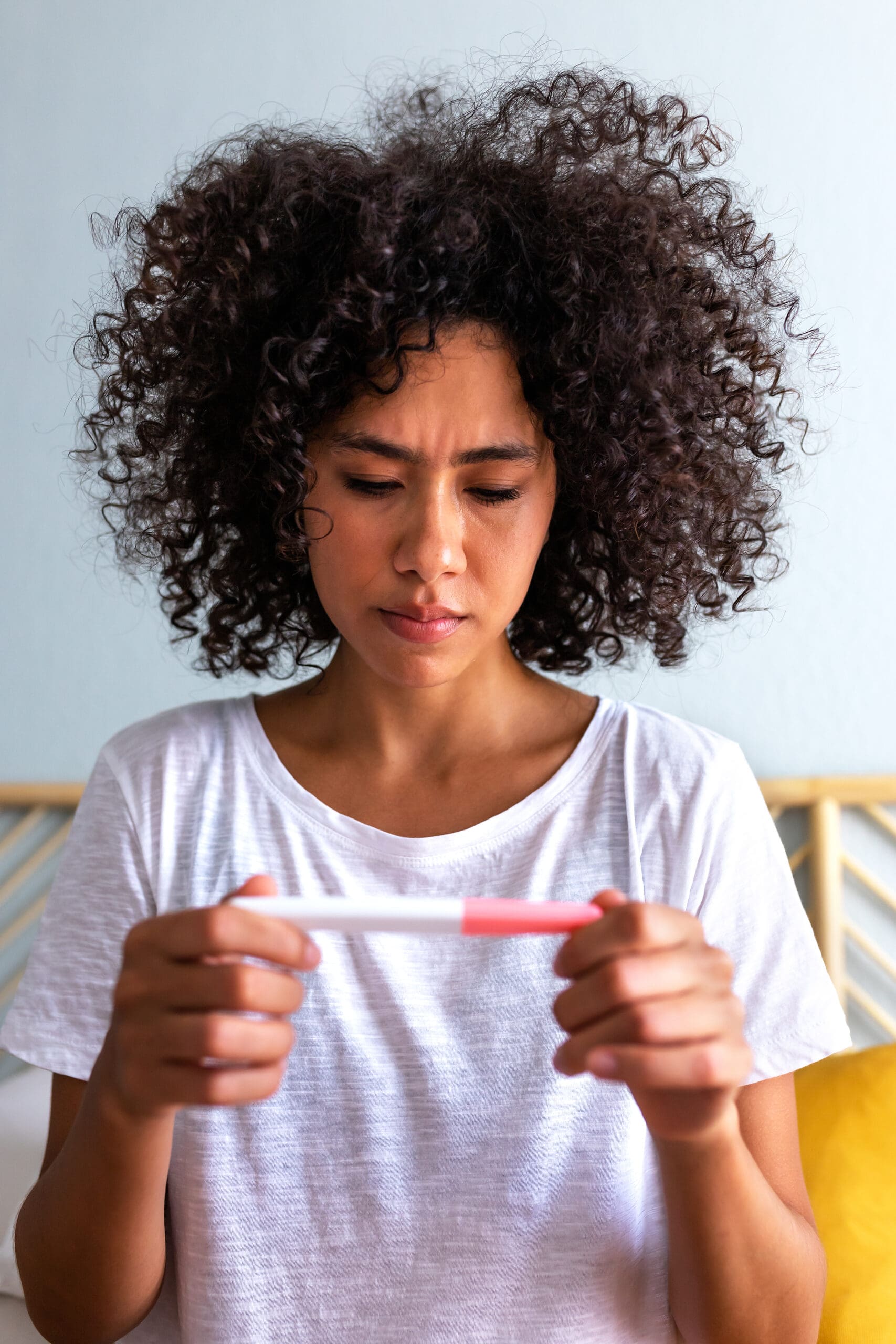 A woman holding a free pregnancy test