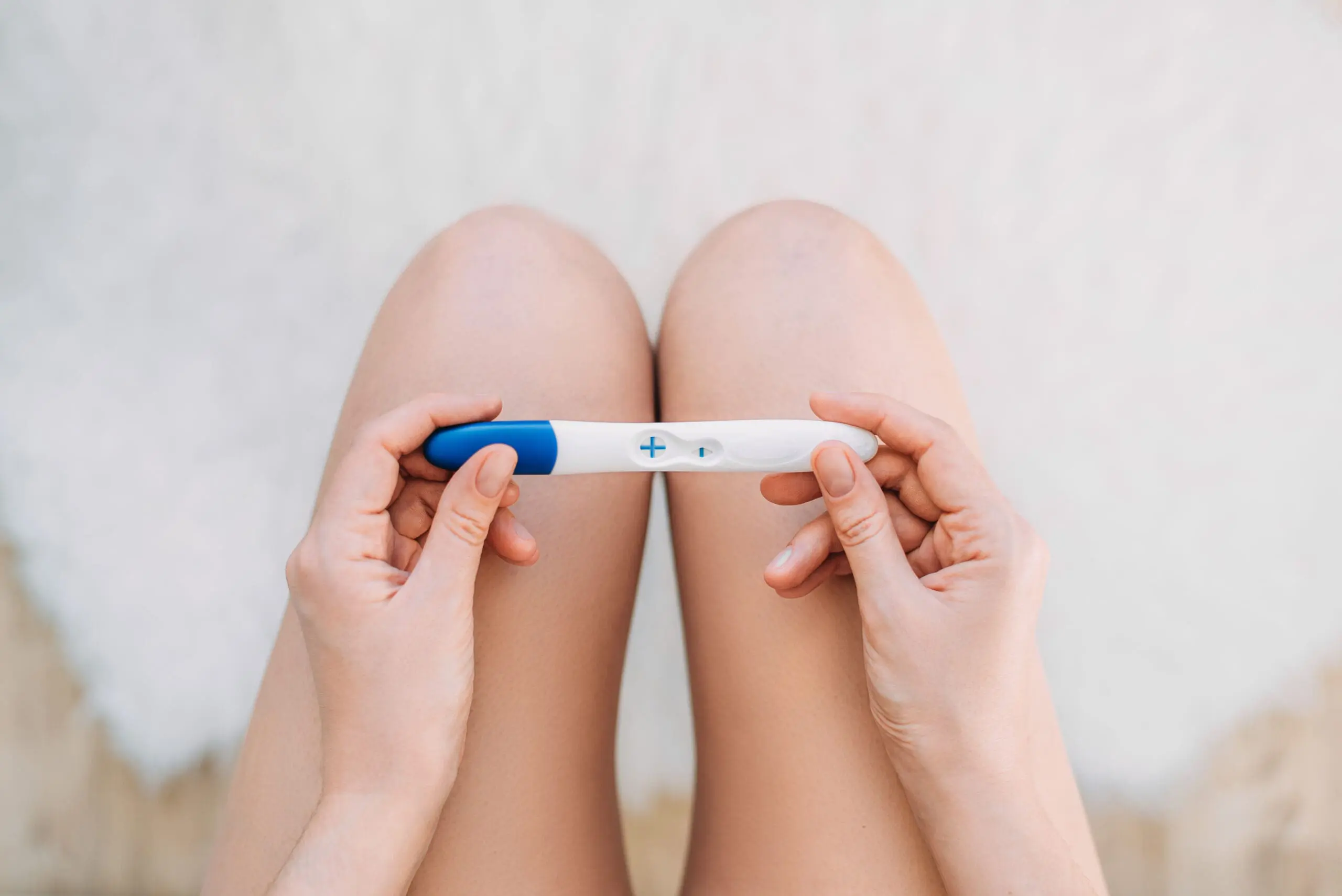 A woman holding a free pregnancy test
