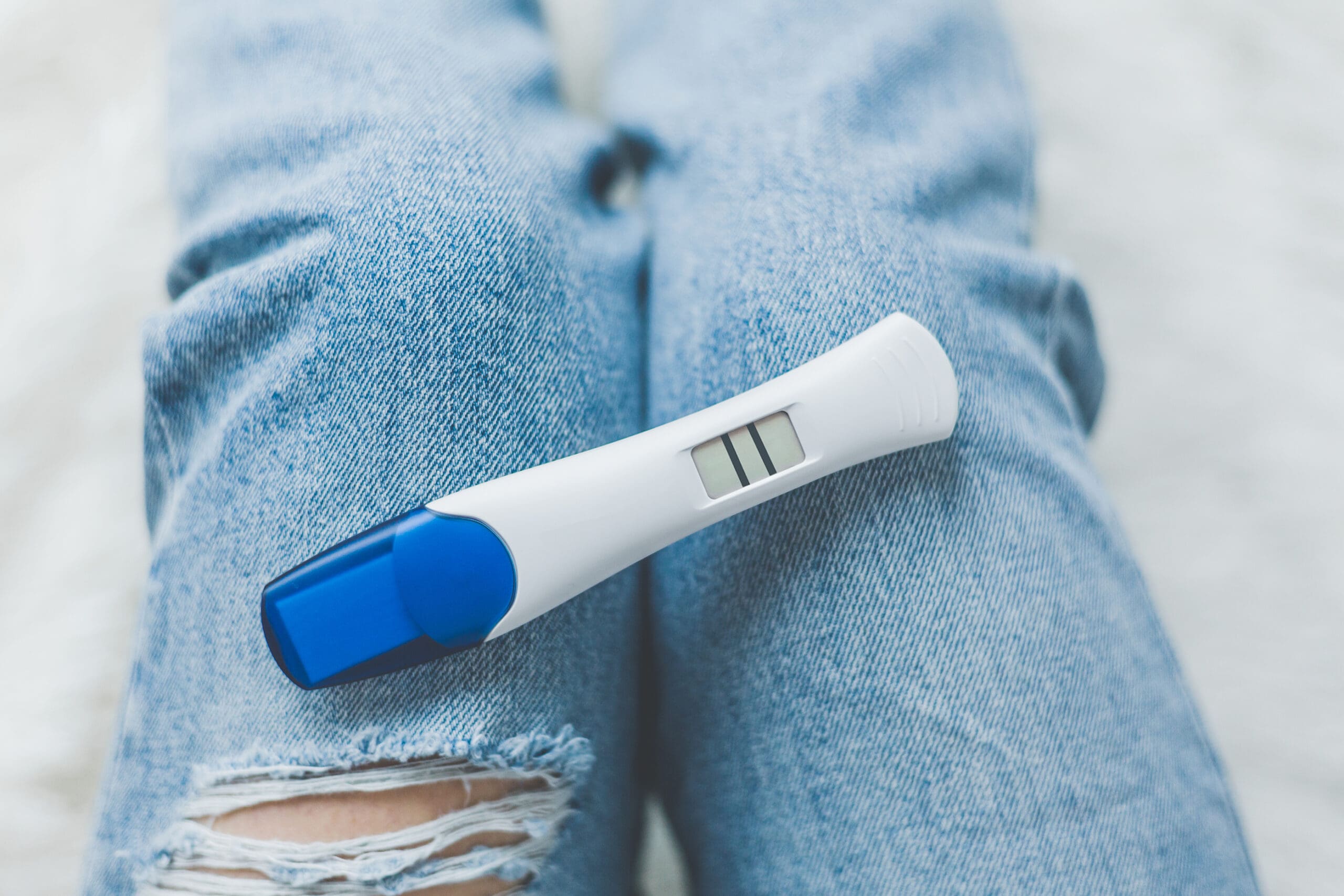 A woman holding a free pregnancy test