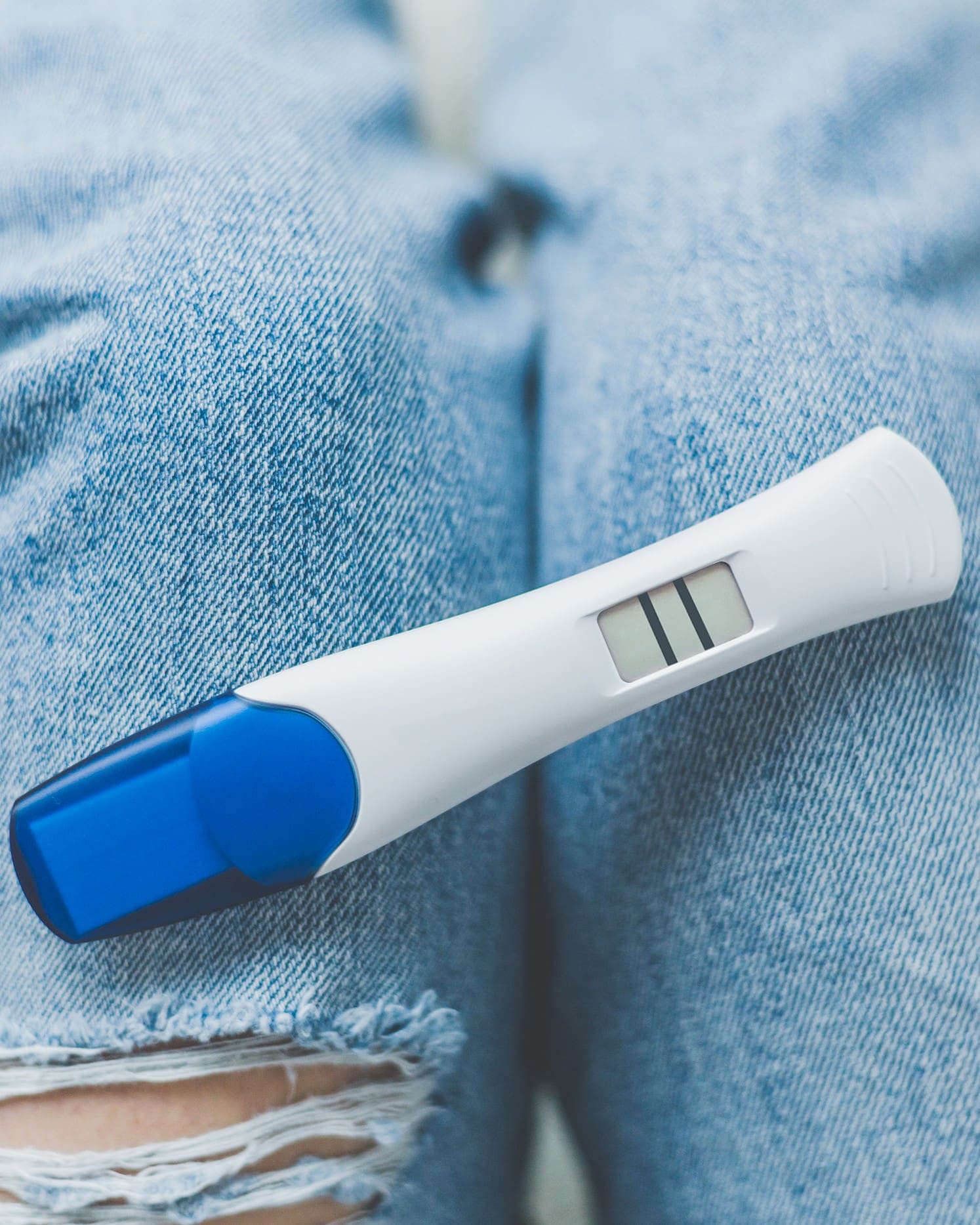 A woman holding a free pregnancy test