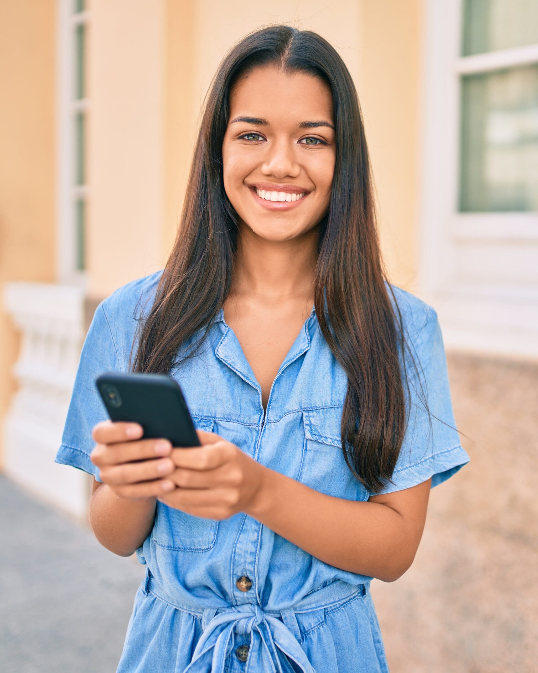 A woman making an appointment on her phone at Expectations Women's Center