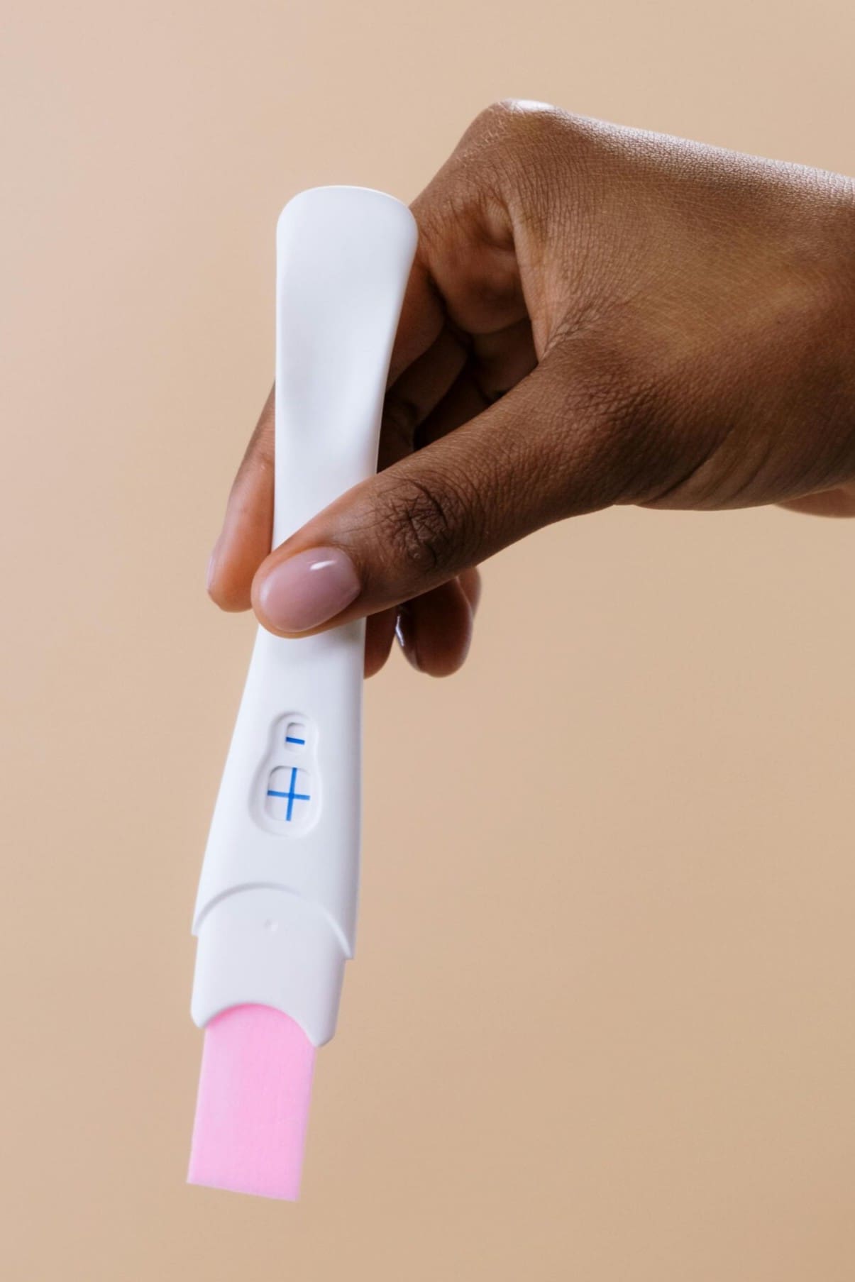 A woman holding a free pregnancy test